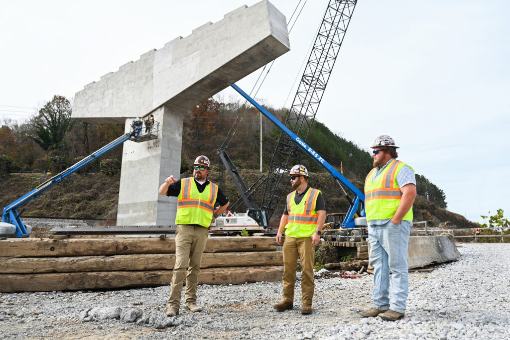 UTC alumni Brian Charlesworth, left and Tanner Dodd and current student Jared Spradlin are part of the Wright Brothers Construction Co. team working on the Apison Pike (State Route 317) project. Photo by Angela Foster.