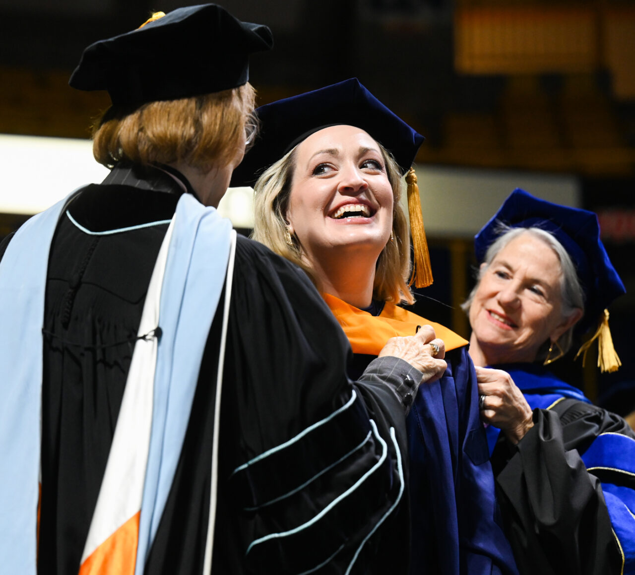 College of Health, Education and Professional Studies Dean Valerie Rutledge, left, and Dr. Chris Smith place the doctoral hood over the head of Rachel Nall—signifying her success in completing the graduate program—during Dec. 16 Graduate Commencement. Photo by Angela Foster.