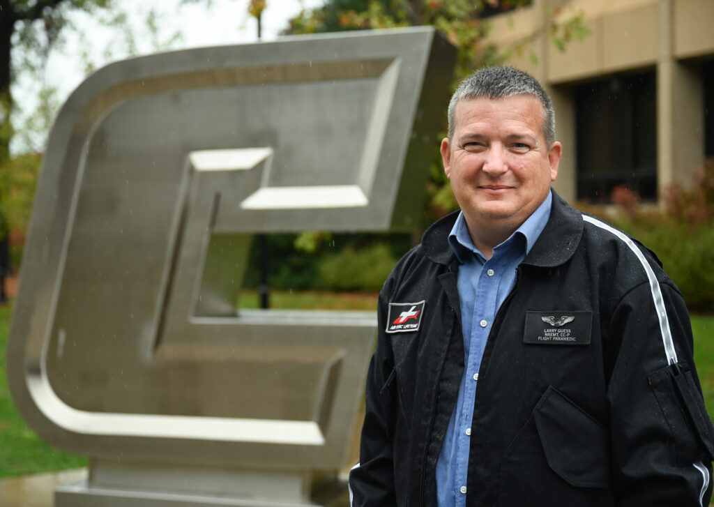 Twenty-five years after his first college class, Larry Guess—an Air Evac Lifeteam helicopter flight paramedic—will soon to able to call himself a first-generation college graduate. Photo by Angela Foster.