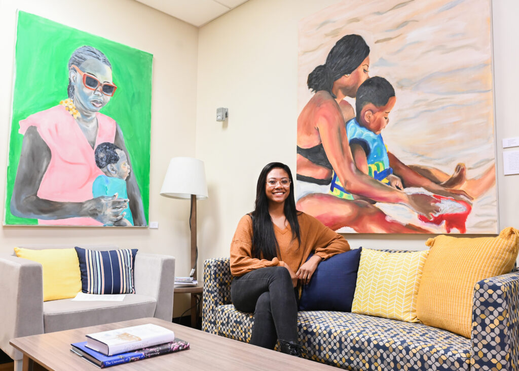 Tamia Spinks sits in front of "Untitled 1" and "Untitled 2."