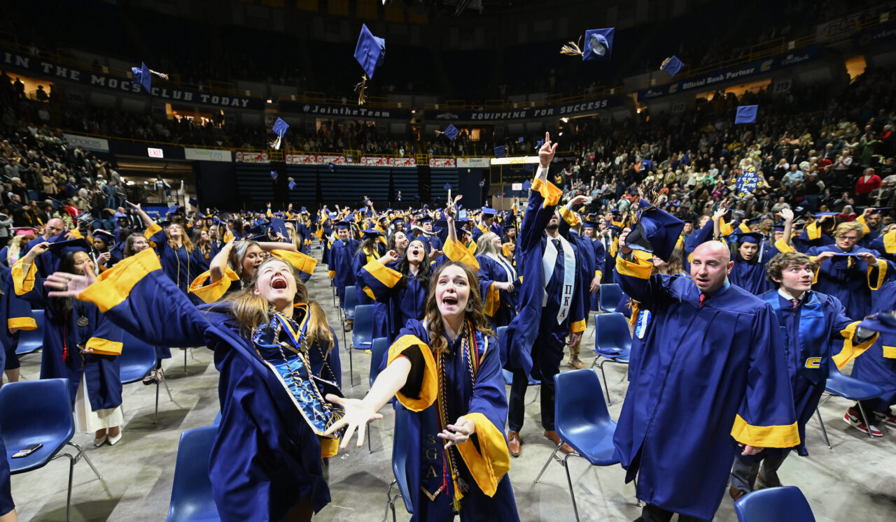 Students throw their caps in the air at the end of the first of two University of Tennessee at Chattanooga undergraduate commencement ceremonies on Saturday, Dec. 17, 2022 in McKenzie Arena.