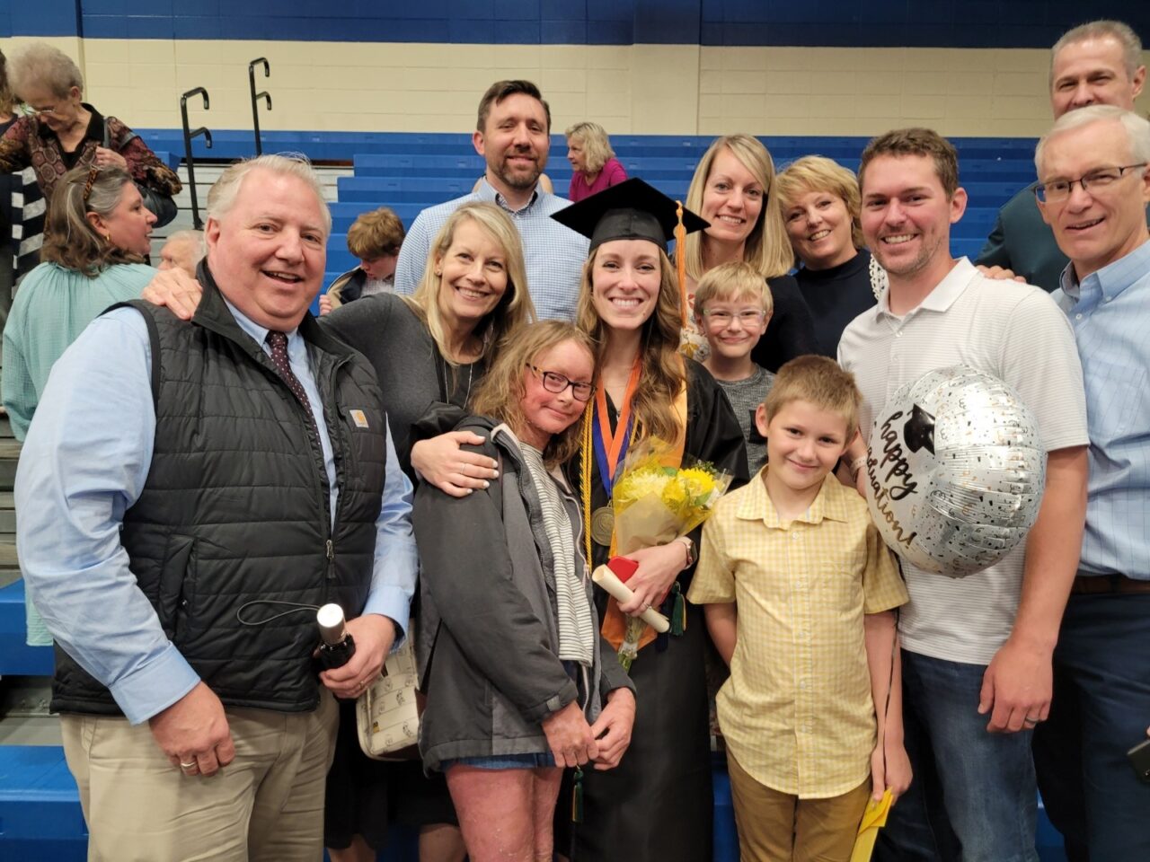 Megan Barrott and her extended family at May 2022 Chatt State commencement, including daughter Hanna, sons Enoch (glasses) and Tekker (yellow shirt), and husband Tyson (white polo).