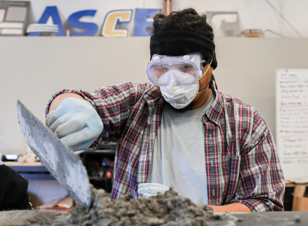 Students work on the concrete canoe Saturday, Feb. 4, 2023 in the ASCE building.