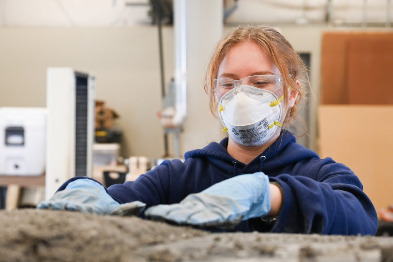 Students work on the concrete canoe Saturday, Feb. 4, 2023 in the ASCE building.