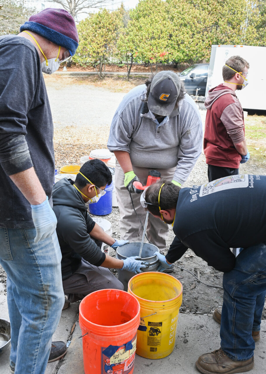 Students work on the concrete canoe Saturday, Feb. 4, 2023 in the ASCE building.