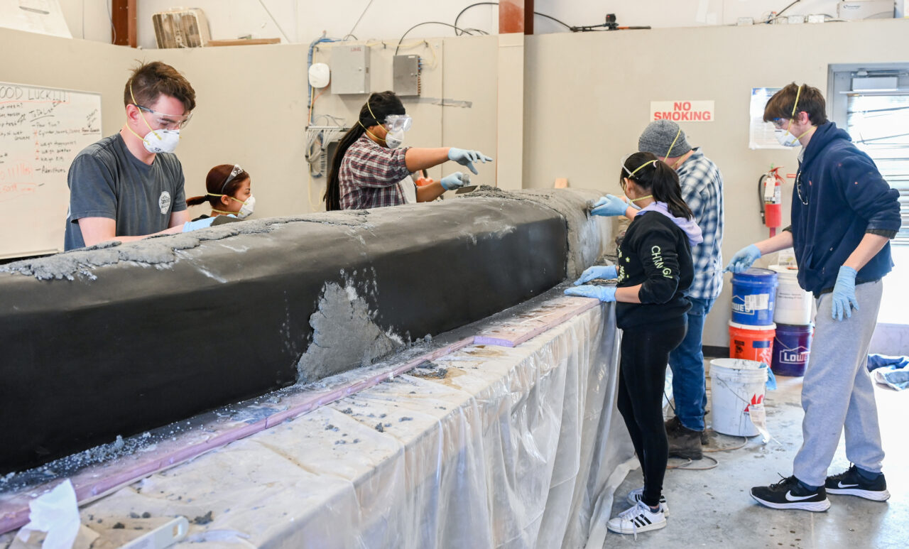 Students work on the concrete canoe Saturday, Feb. 4, 2023 in the ASCE building.