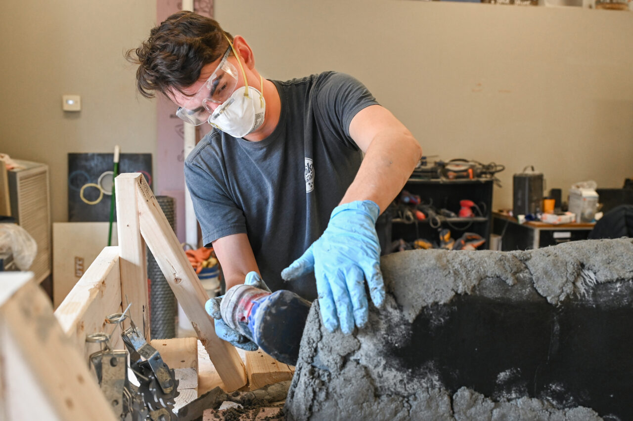 Students work on the concrete canoe Saturday, Feb. 4, 2023 in the ASCE building.