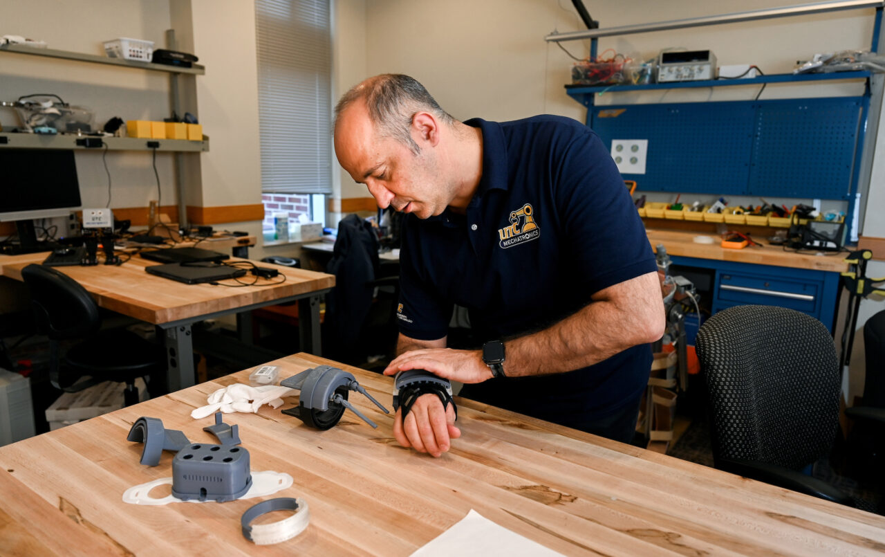 Erkan Kaplanoglu demonstrates his device that can control hand tremors. Photo by Angela Foster.