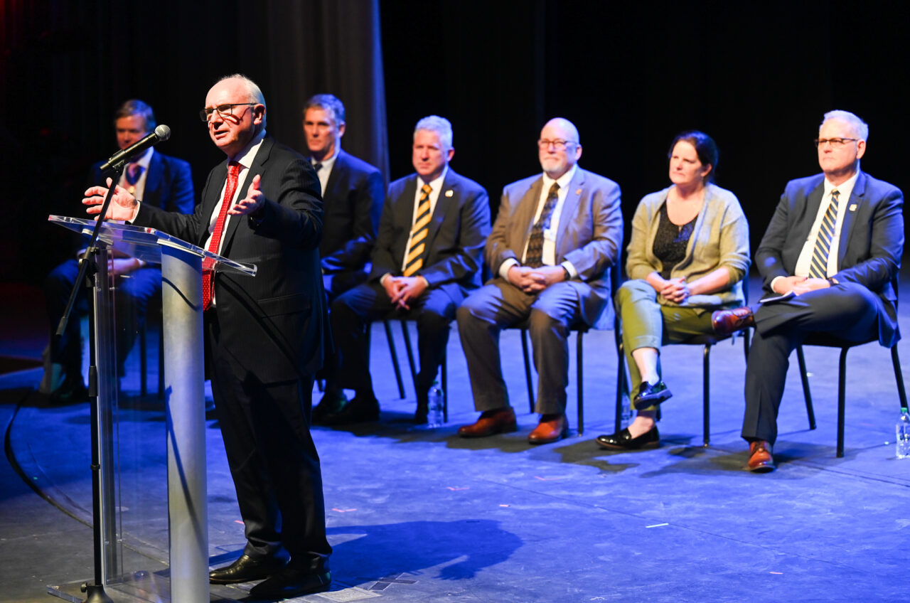 Bob Bone, parade founder and chair, talks Wednesday, March 22, 2023 in the Hayes Concert Hall before London officials present the Marching Mocs with their official invitation to participate in the London New Year’s Day Parade.