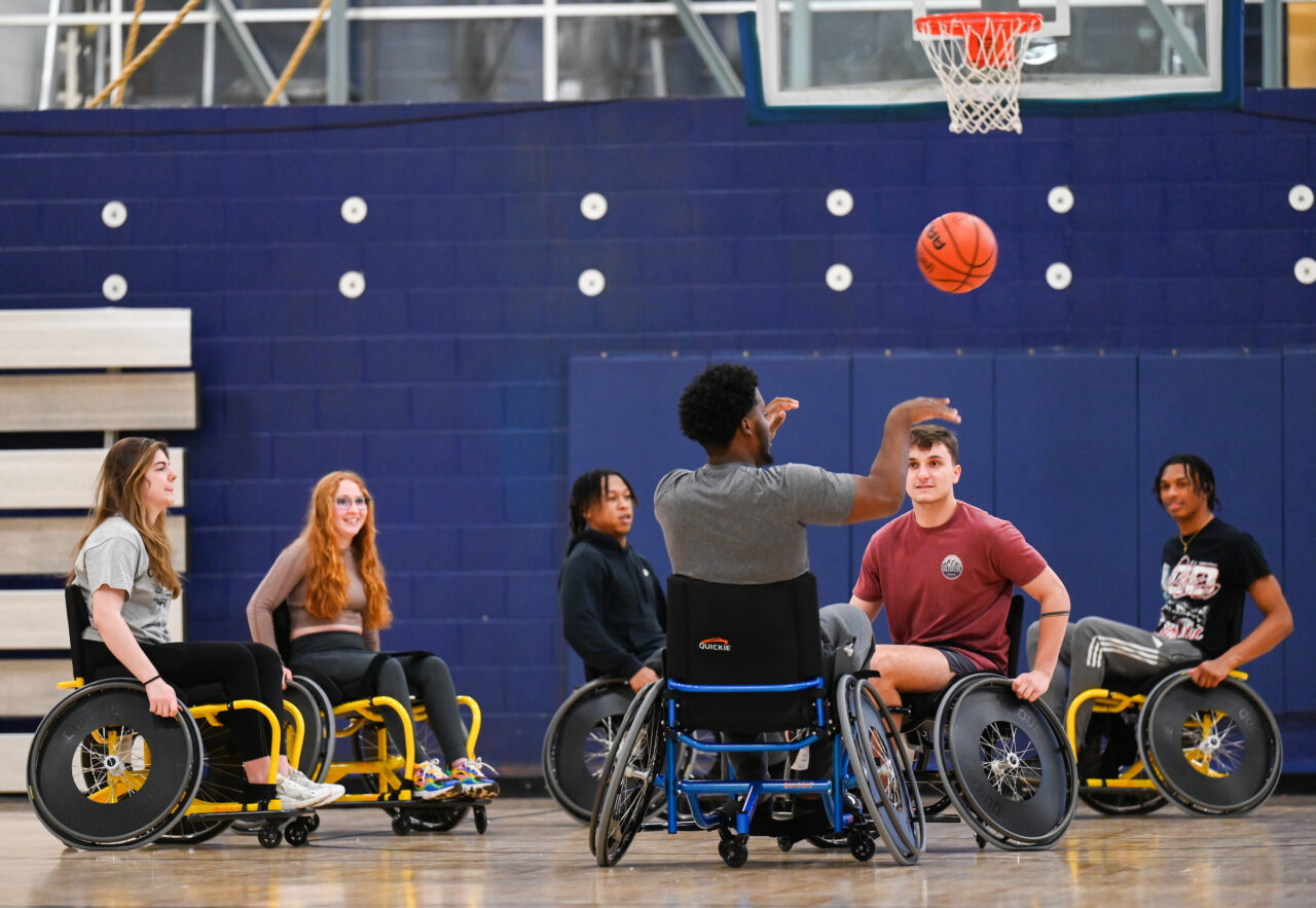 Students play wheelchair basketball in Craig Gosnell’s adapted physical education class. Photo by Angela Foster.