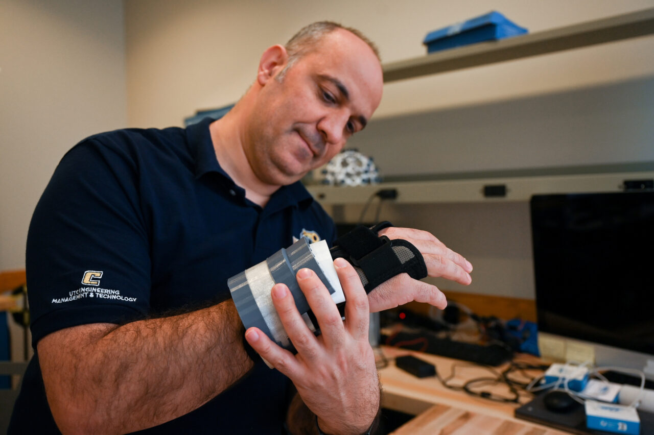 Dr. Erkan Kaplanoglu demonstrates his device that can control hand tremors.