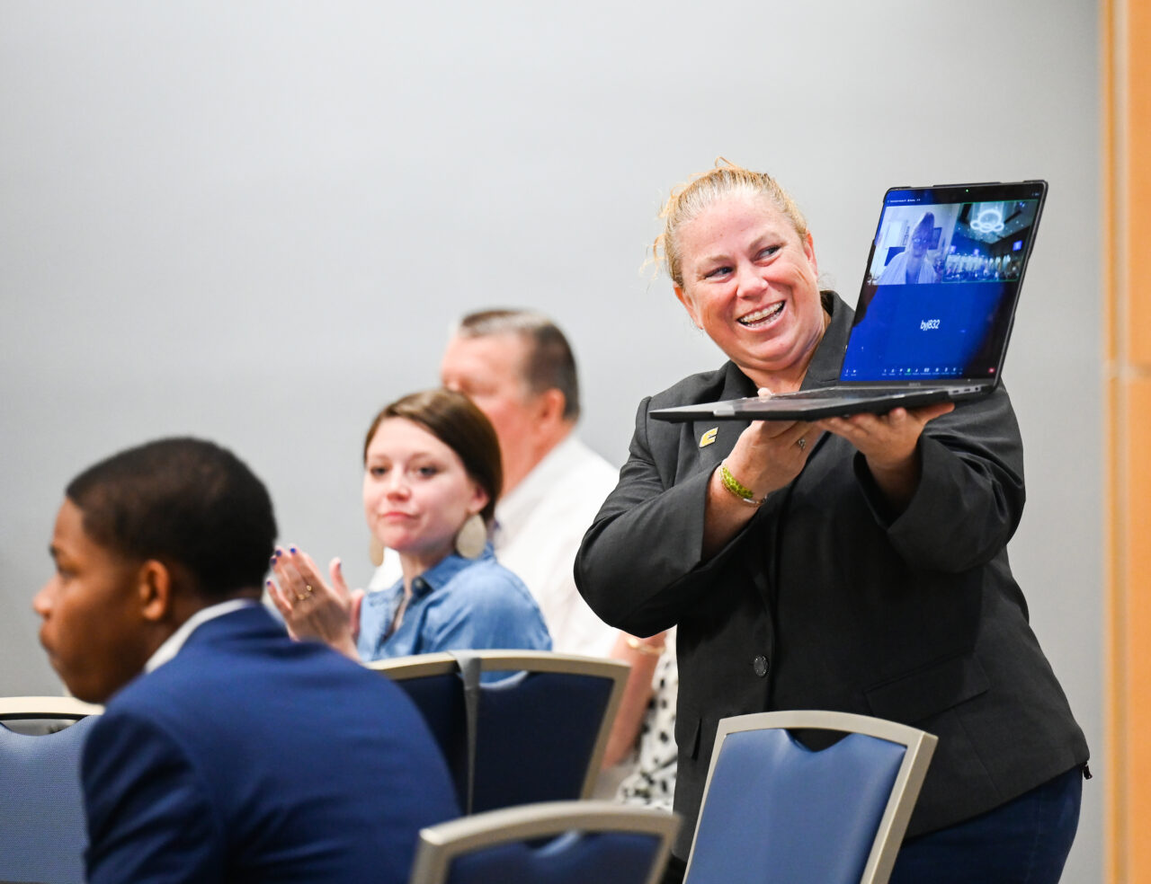 Dr. Jennifer Lynberg holds a laptop for Martha Butterfield, who watched the event via Zoom