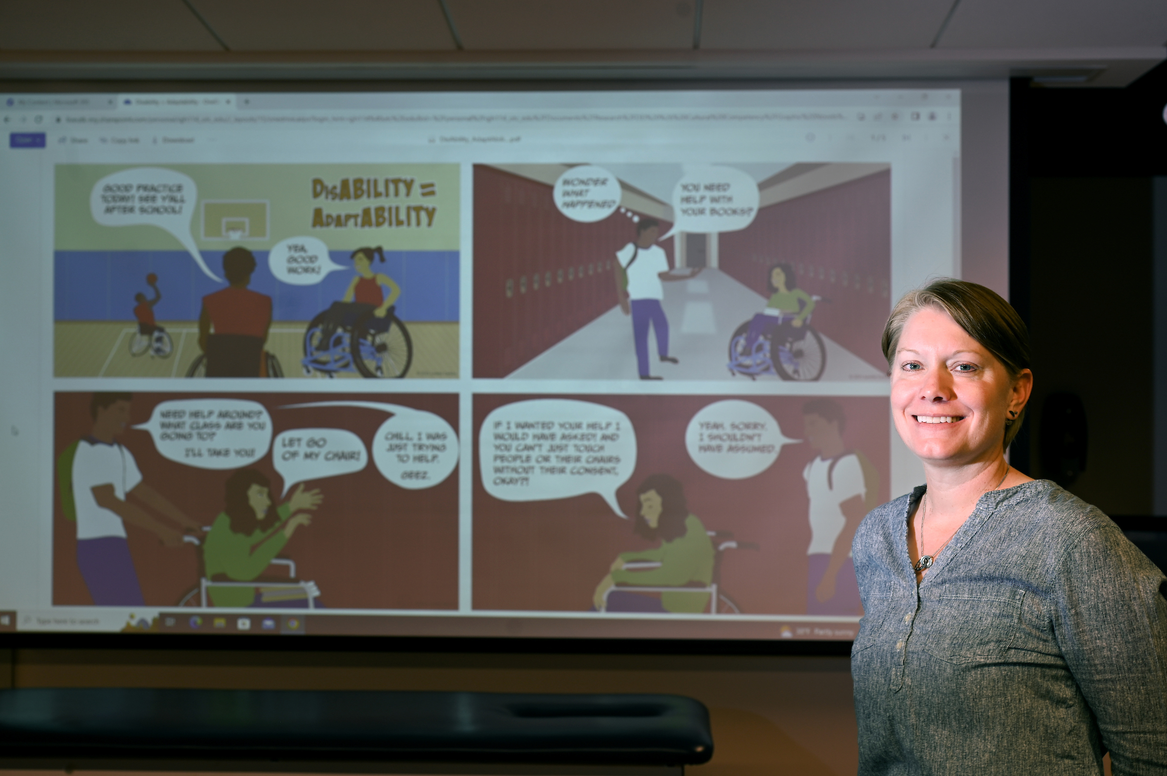 Dr. Lynette Carlson uses a graphic novel to spark conversation in class. Photo by Angela Foster.