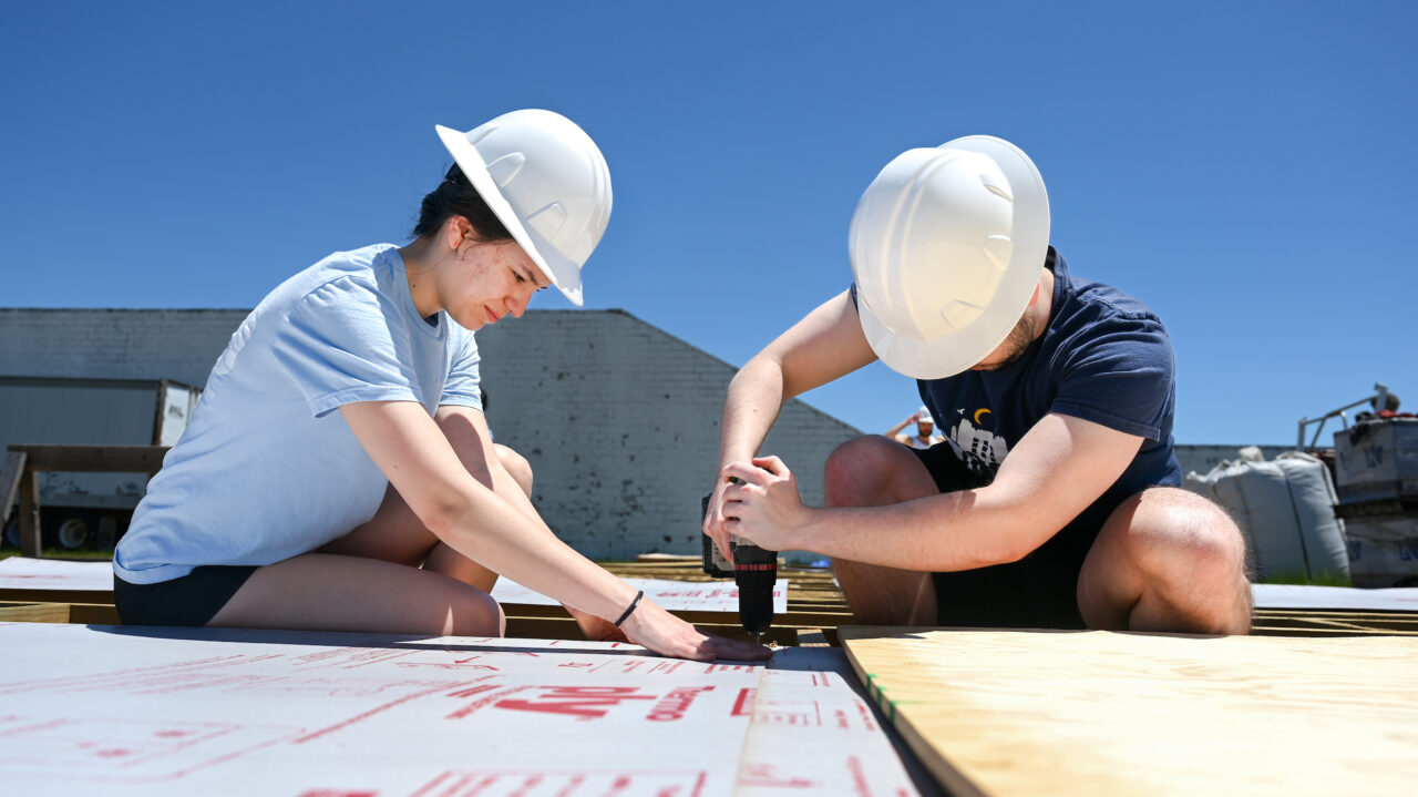 Members of the Solar Decathlon team work Wednesday, May 3, at Engel Stadium. Photo by Angela Foster.