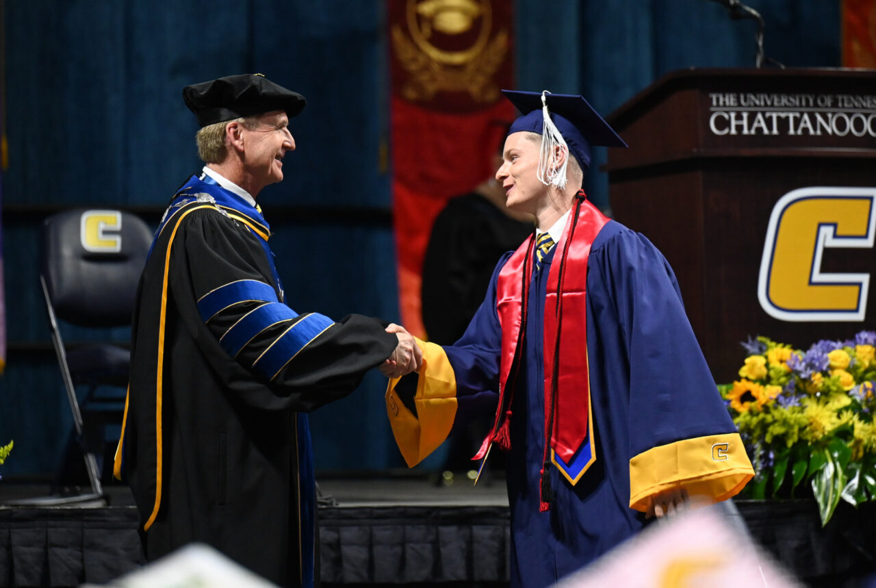 Chancellor Steven Angle congratulates Dru Schenk during the May 6 commencement ceremony.