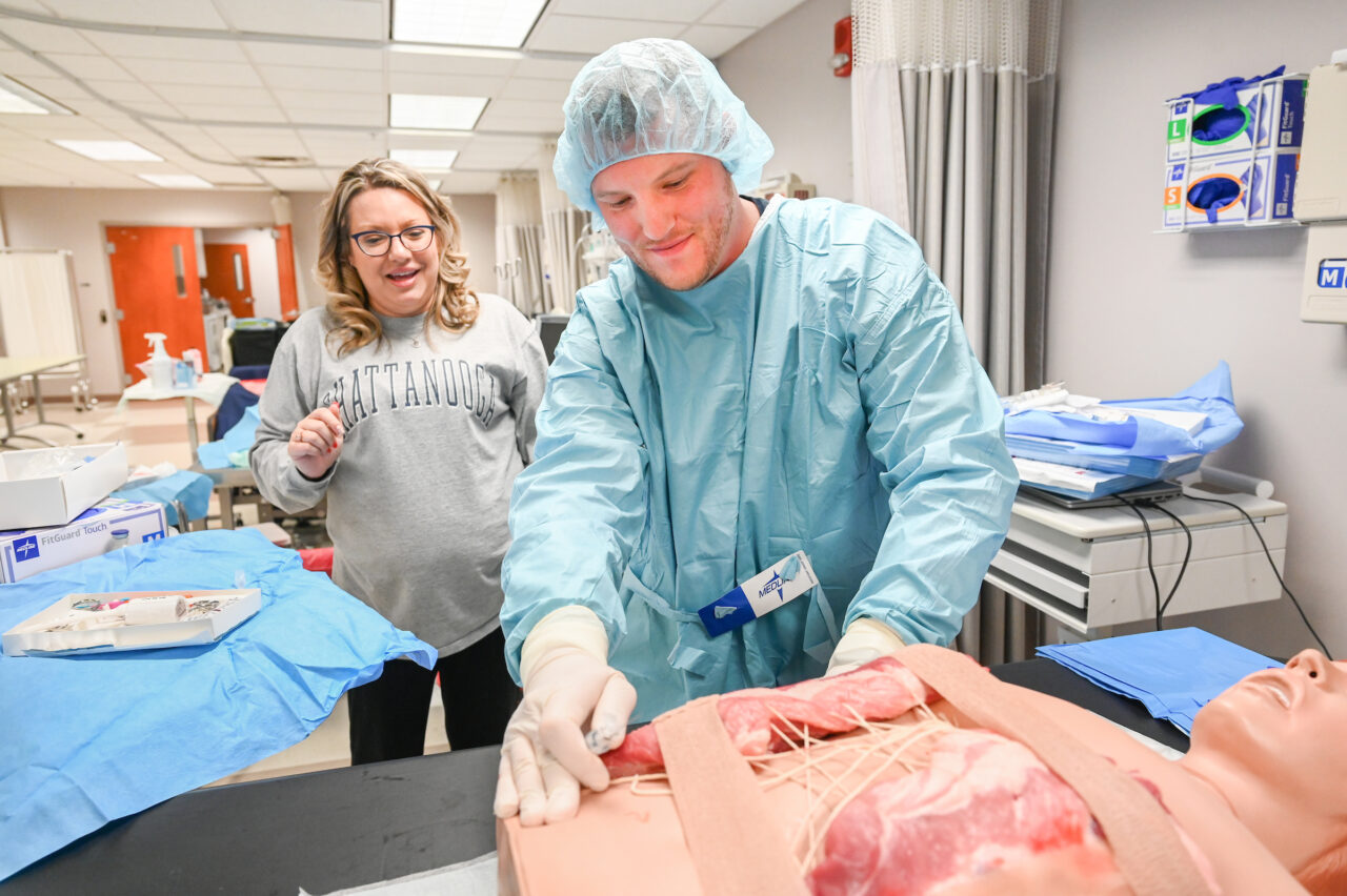 Students work in Dr. Christi Denton’s acute care nurse practitioner class in the Metro Building. Photo by Angela Foster.