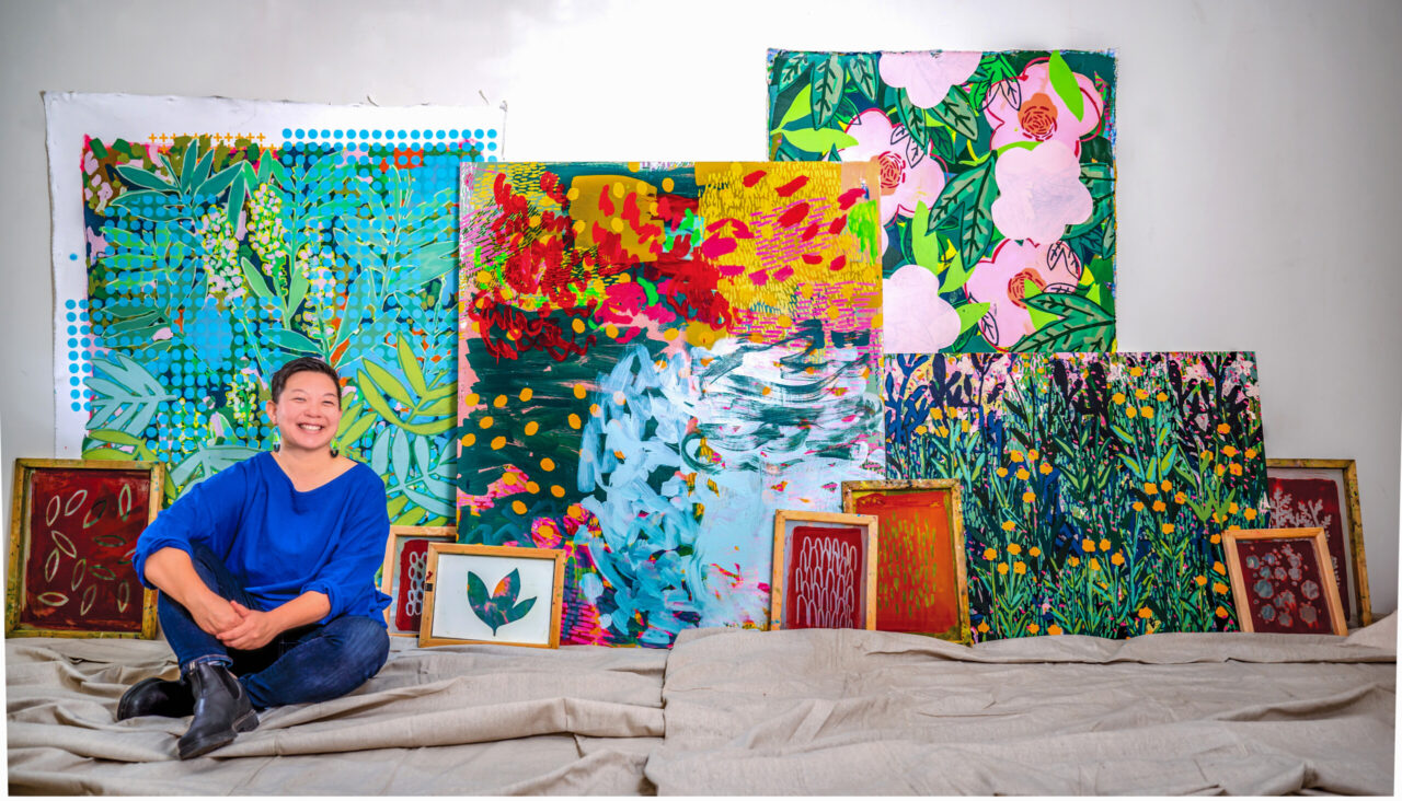 Angie To, sitting in front of different pieces of her artwork, joined the UTC Department of Art in July 2021. Photo by Angela Foster.