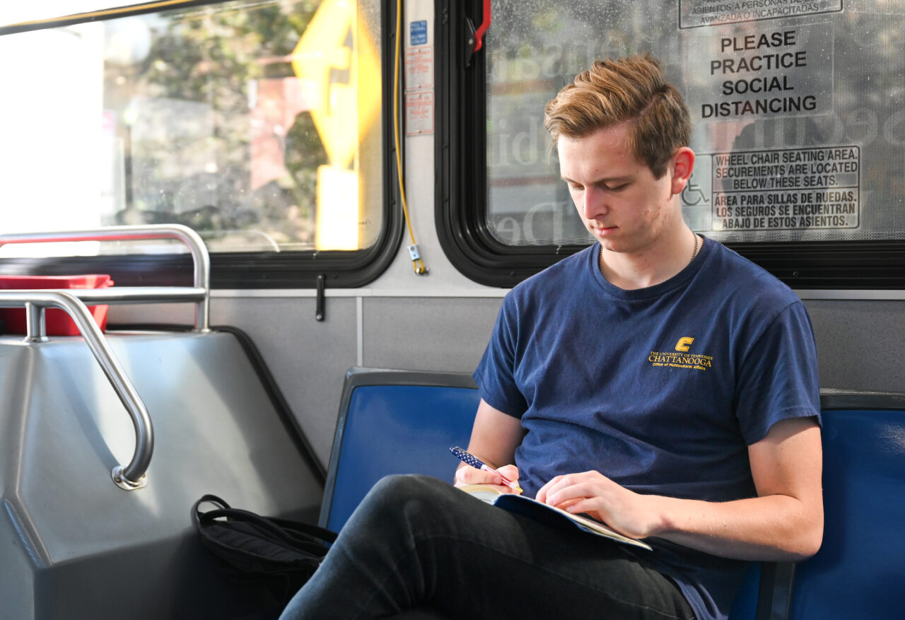 Graduate student Arsen Martyshchuk rides a CARTA bus Friday in downtown Chattanooga. He is working with CARTA on projects related to public transit service. Photo by Angela Foster.