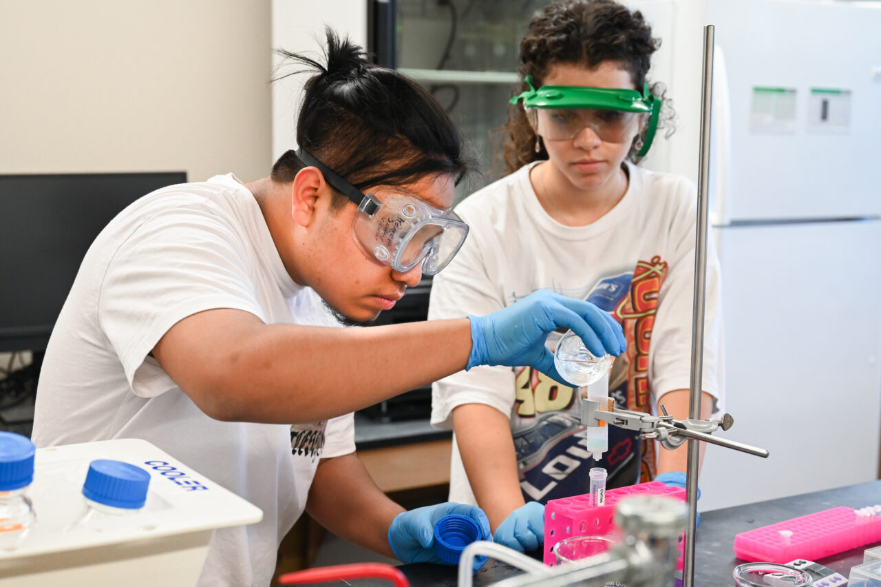 UTC student Zayda Dominick, right, works with high school student Kenneth Sontay Vicente in Grote Hall. Photo by Angela Foster.