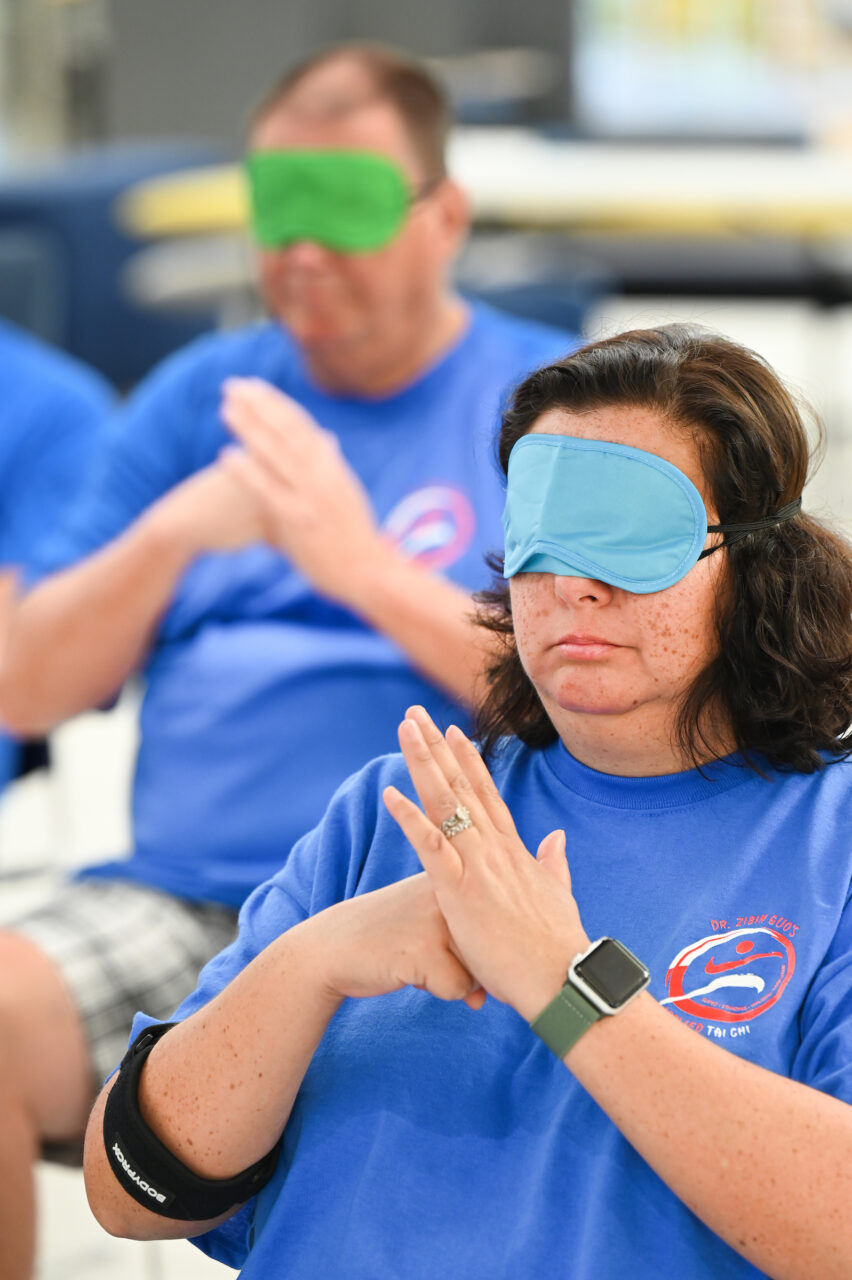 Zibin Guo and others participate in three-day Wheelchair Tai Chi for Veterans seminar Thursday, June 8, 2023 in Lupton Hall.