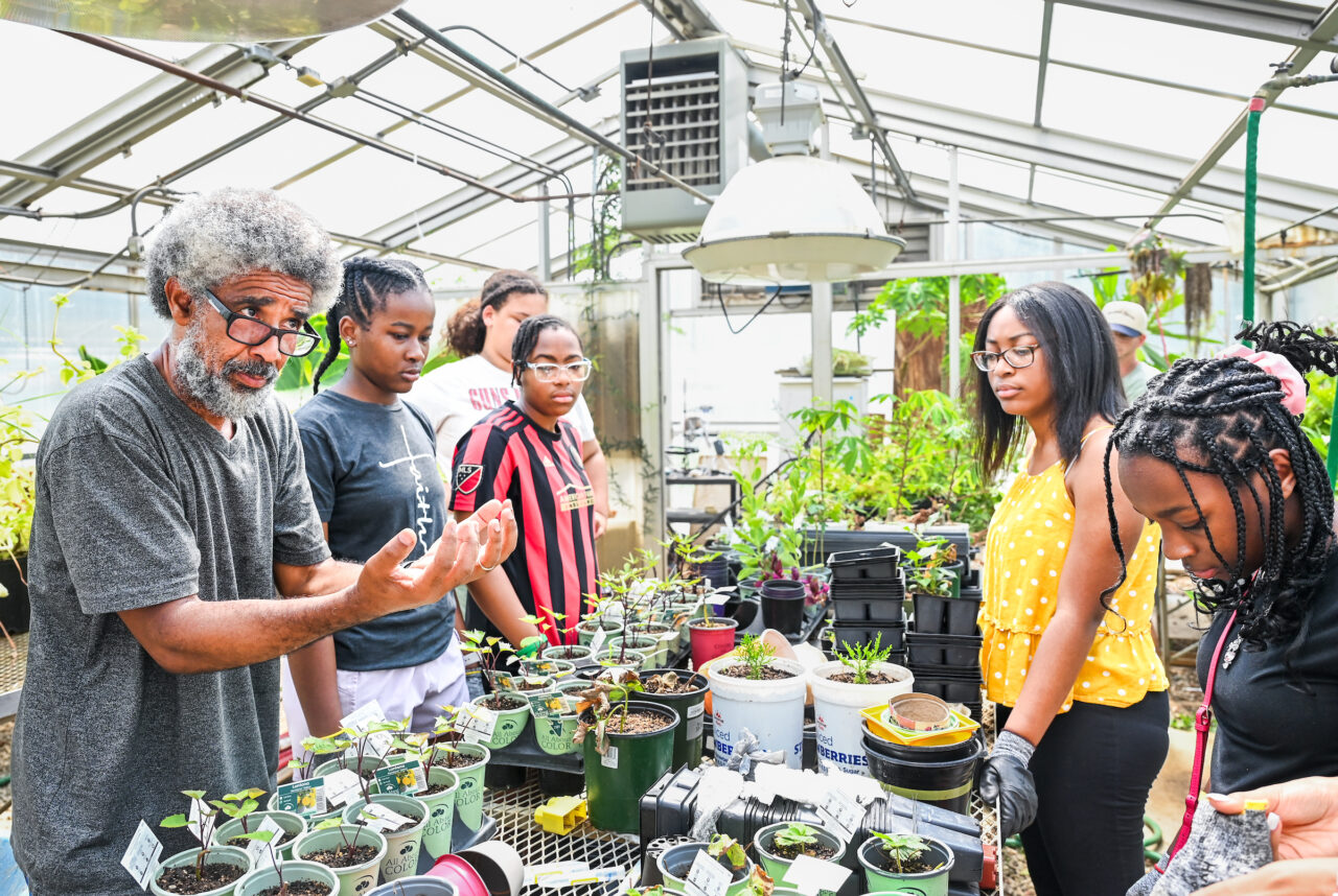 Dr. Jose Barbosa, left, and members of the ANGELS camp work in the Teaching and Learning Garden near Holt Hall.