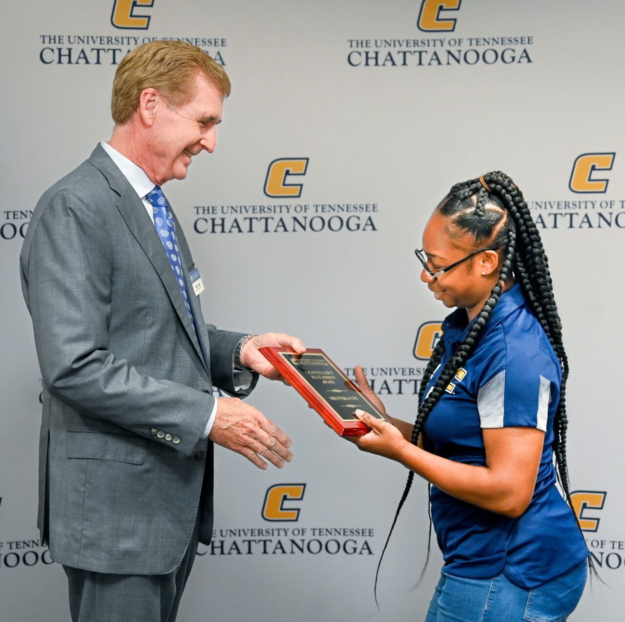 Chancellor Angle presents Shuntika Cox with the Chancellors' Blue Ribbon Award for May 2023.
