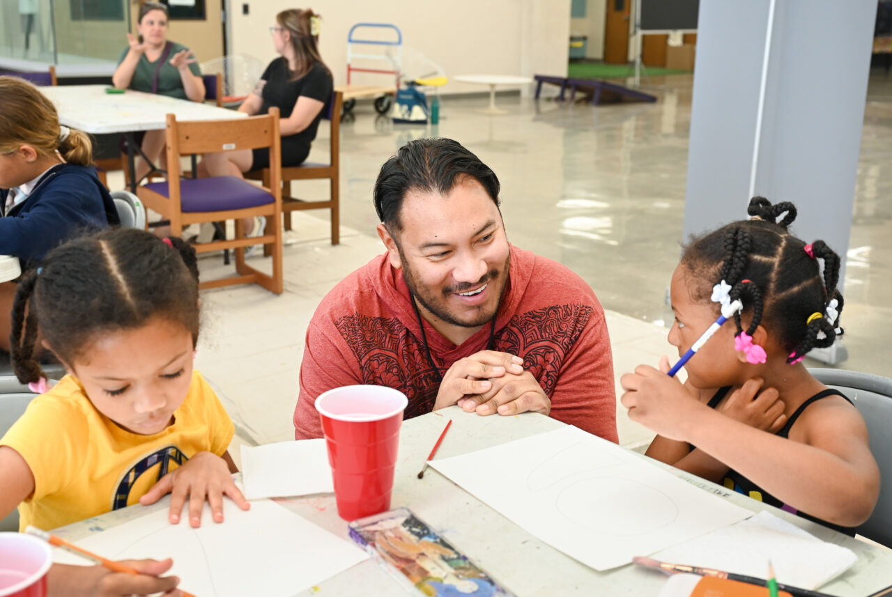 Recent UTC graduate Heber Gutierrez is an opportunity fellow with ArtsBuild's SPLASH program, working with children to teach the fundamentals of art. Photo by Angela Foster.