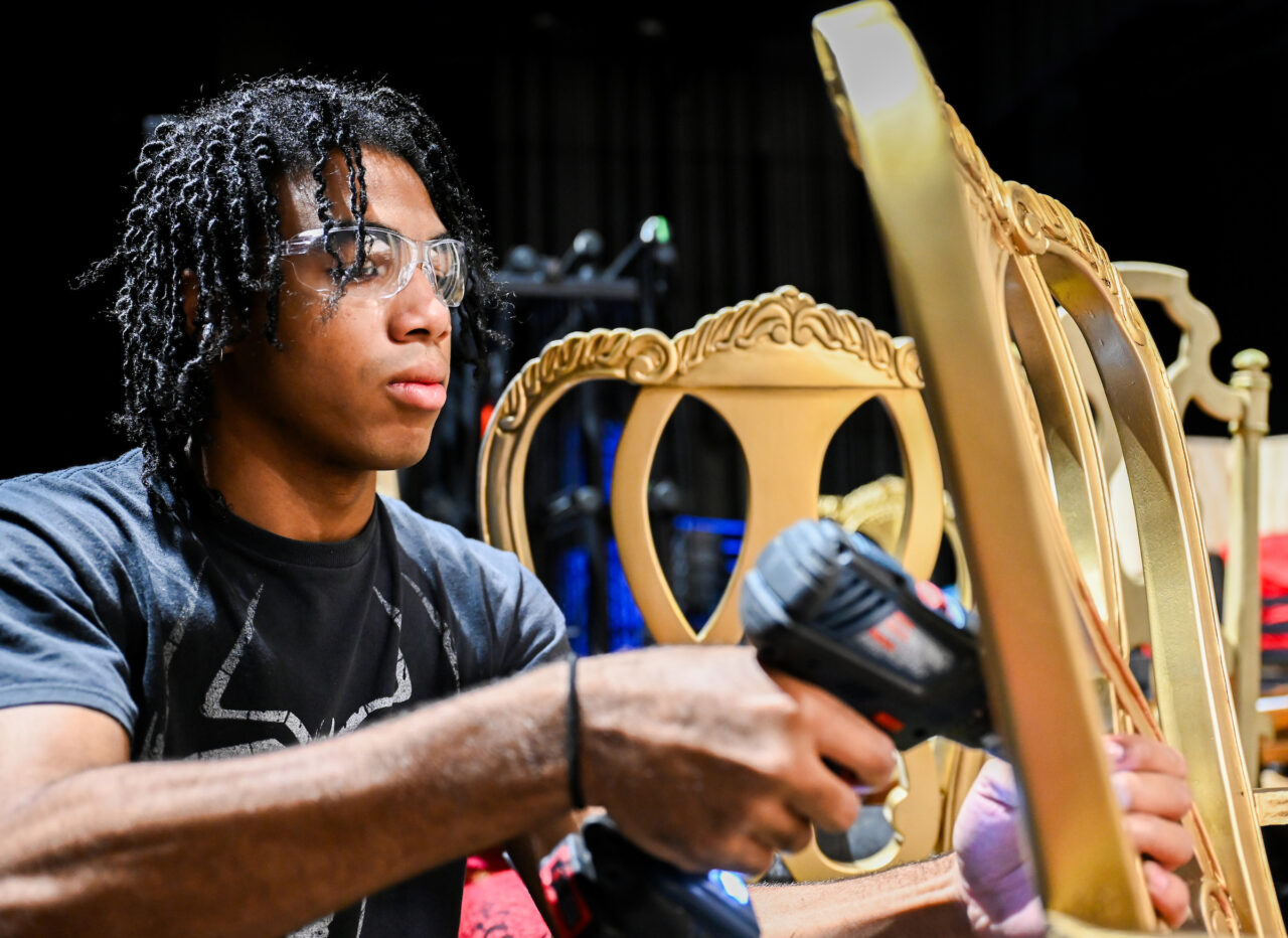UTC theatre major Lio Mercedes Sosa works on the set for of the Obvious Dad production "LEAR." Photo by Angela Foster.