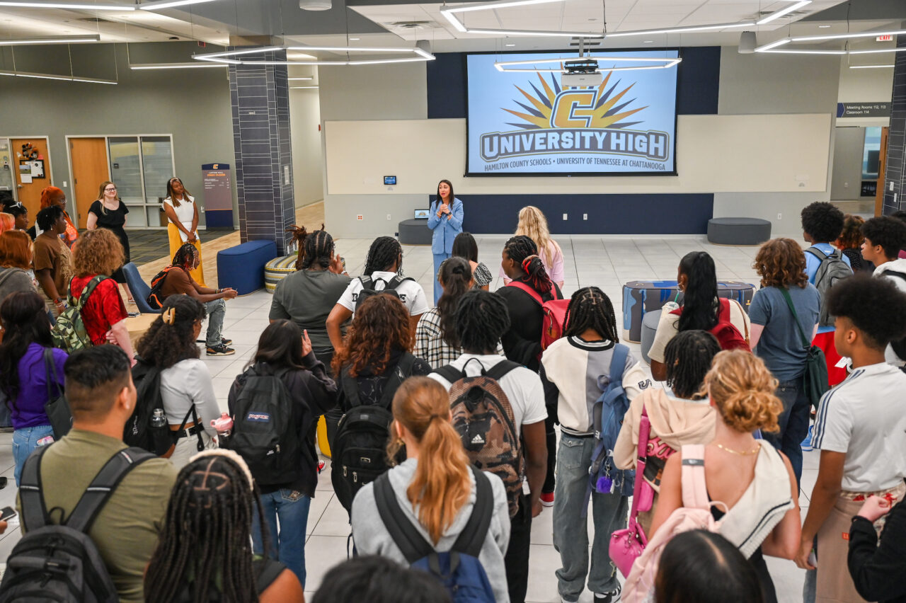 Principal Arielle Hayes, standing in Lupton Hall, welcomes students to the first day of University High. Photo by Angela Foster.