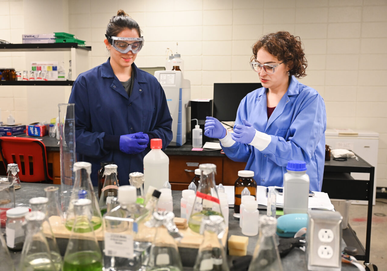 Junior Sam Doss-Watson, left, an environmental geology student, learns from Dr. Ashley Manning-Berg in her Grote Hall lab. Photo by Angela Foster.