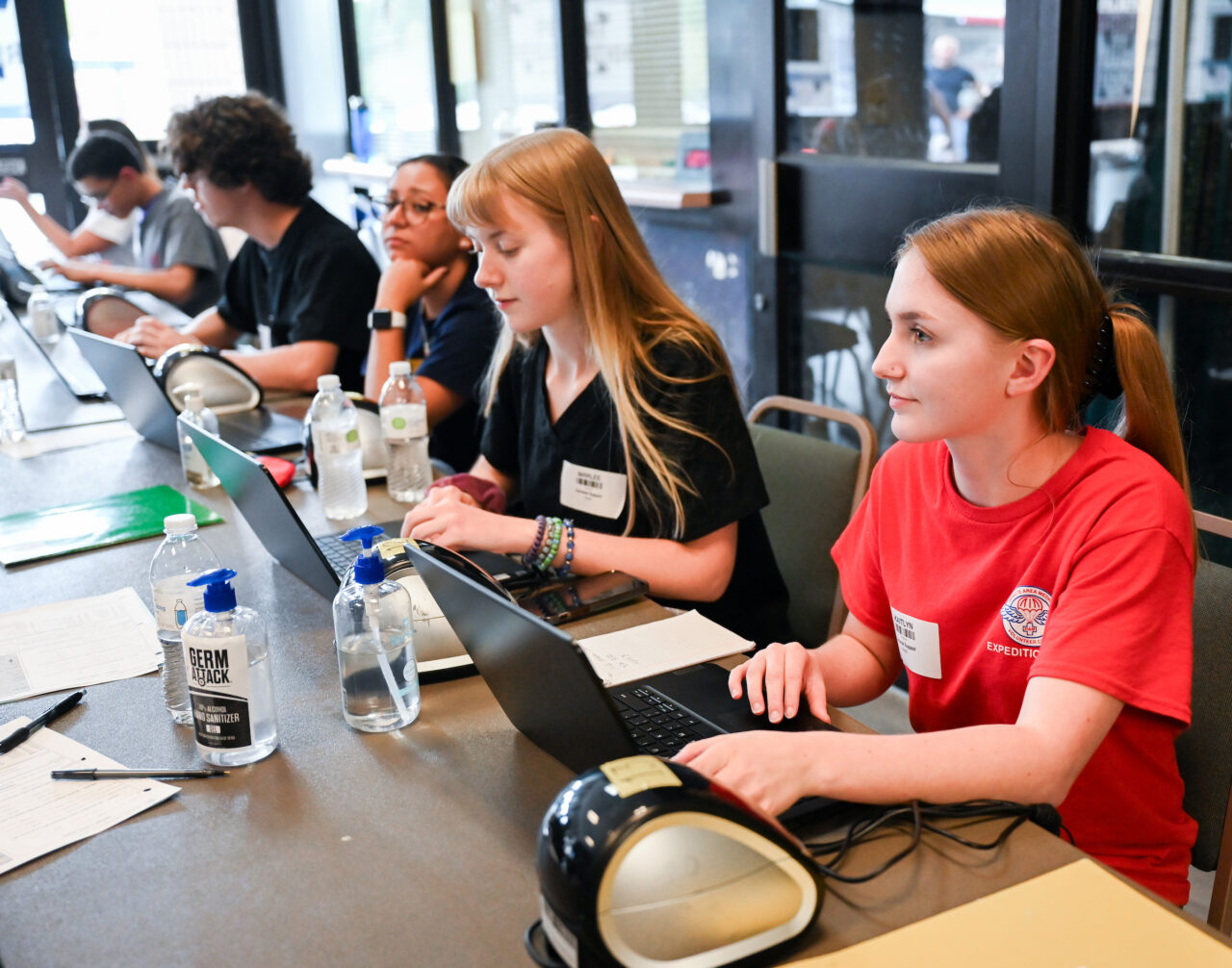 Kaitlyn Acuna, right., and members of UTC's student RAM chapter checked in patients as they entered the Camp Jordan Arena facility.
