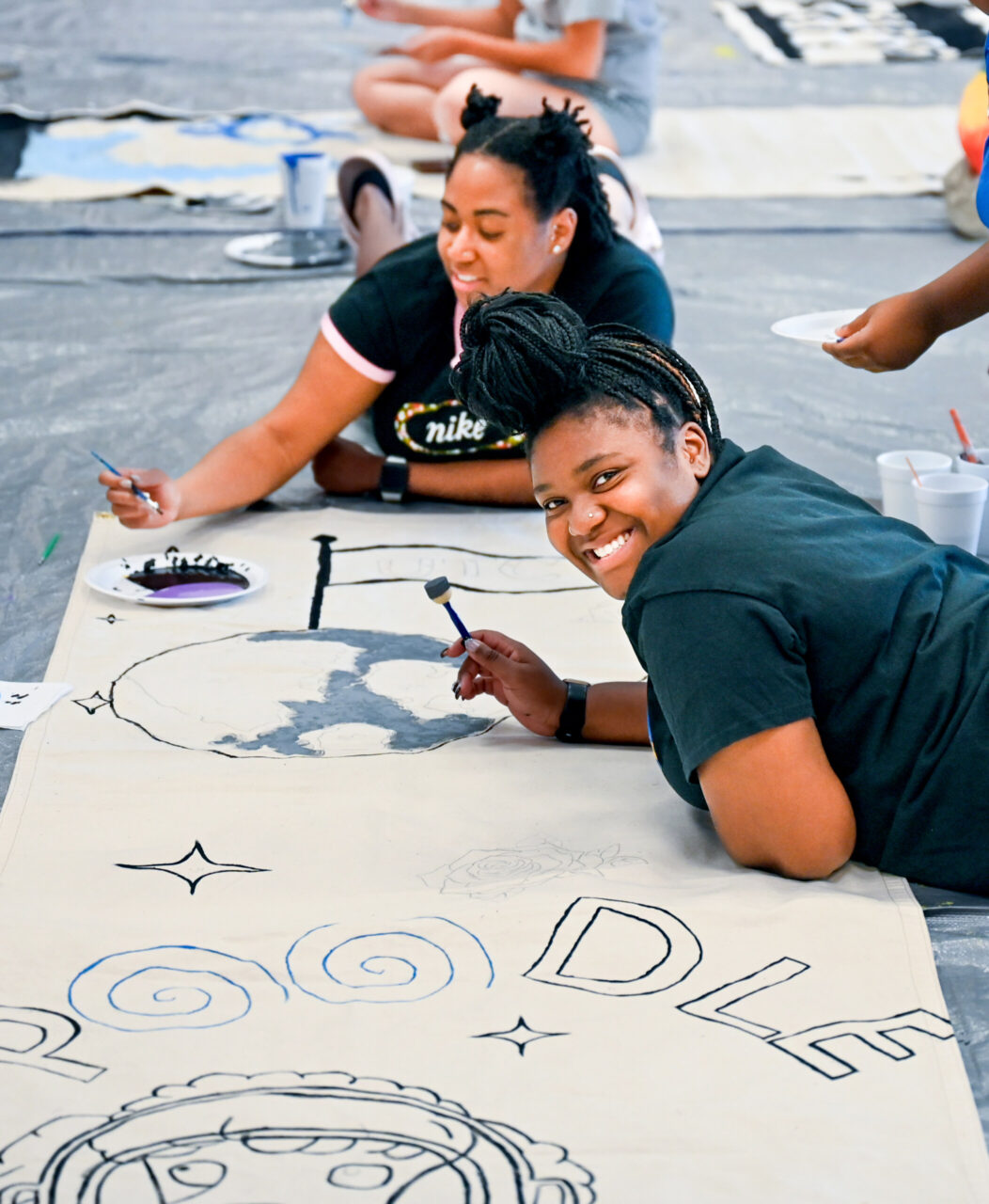 Students paint Homecoming banners Sunday, Oct. 1, 2023 in the University Center.