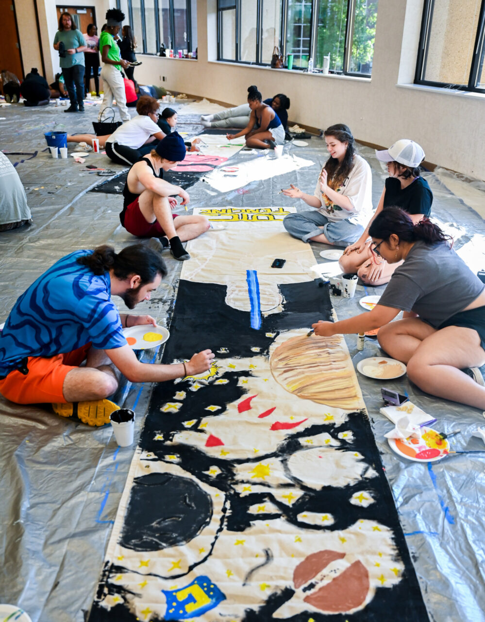 Students paint Homecoming banners Sunday, Oct. 1, 2023 in the University Center.