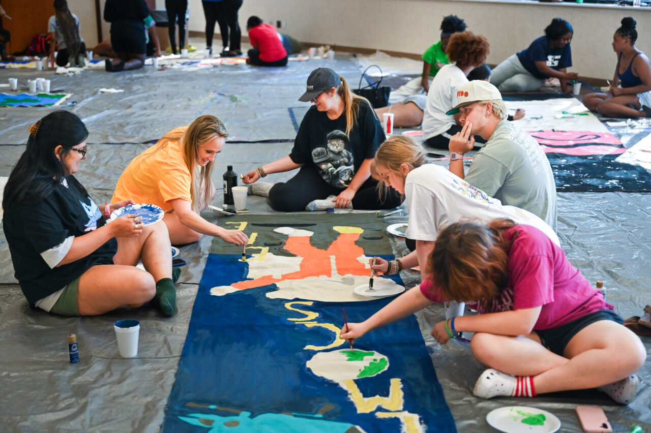 Students paint Homecoming banners Sunday, Oct. 1, 2023 in the University Center.