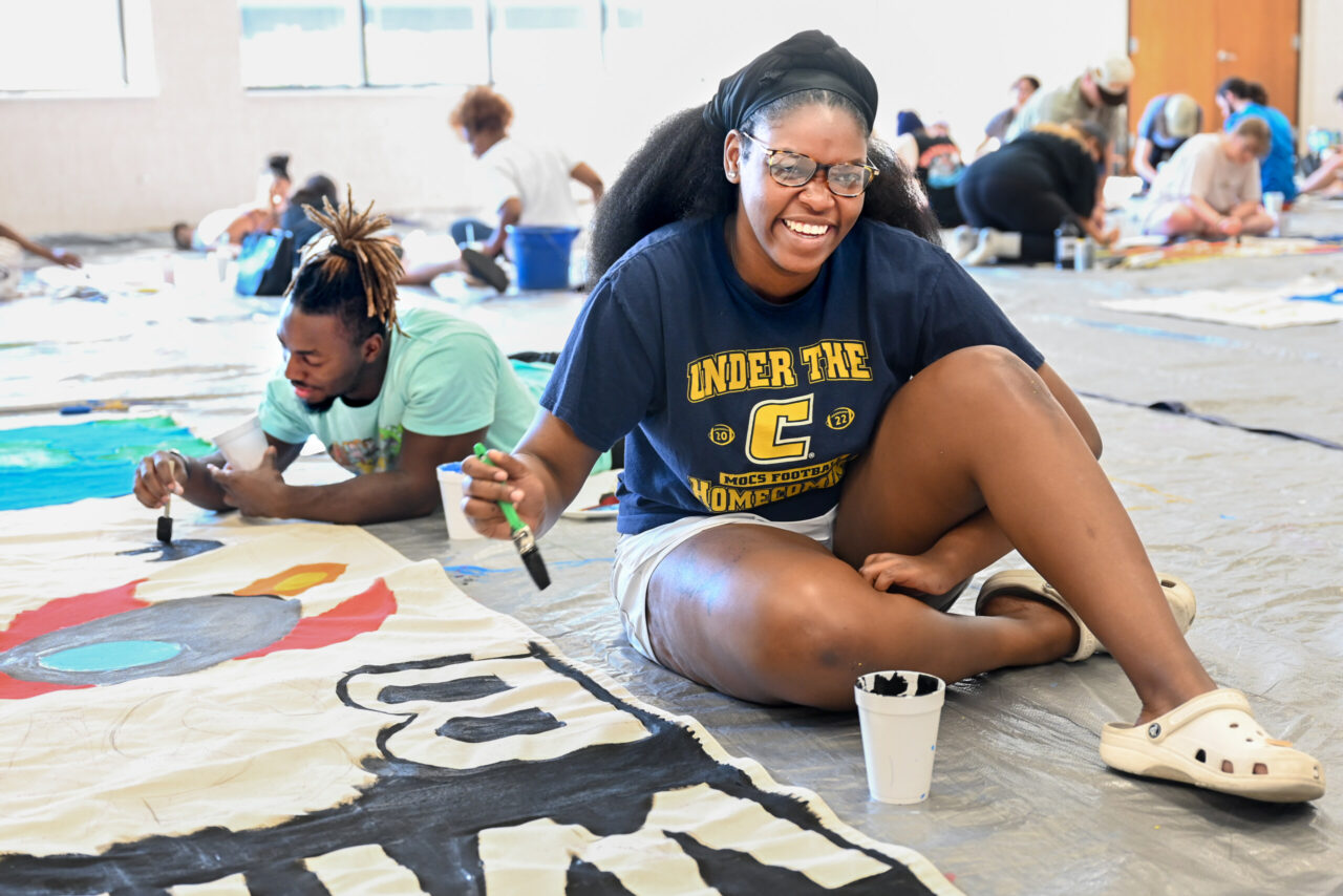 Students paint Homecoming banners Sunday, Oct. 1, 2023 in the University Center.