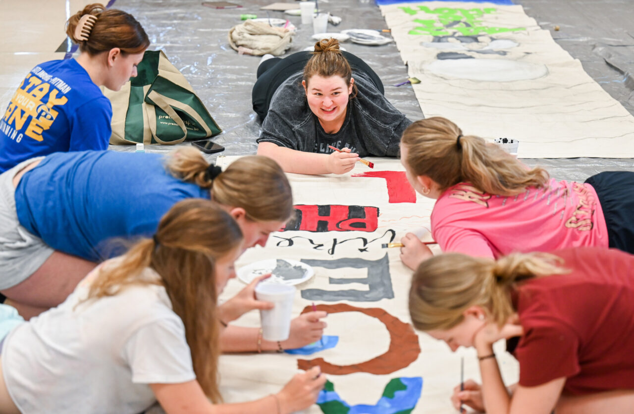 Students paint Homecoming banners Sunday, Oct. 1, 2023 in the University Center.