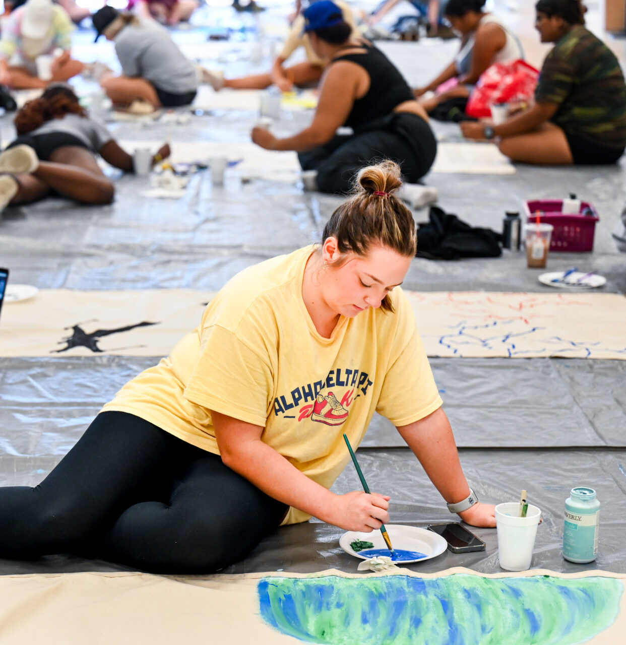 Students paint Homecoming banners Sunday, Oct. 1, 2023 in the University Center.