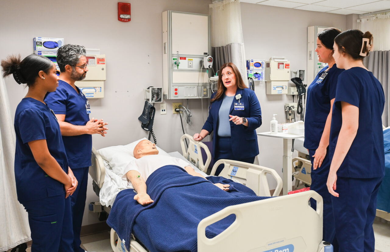 Dr. Brooke Epperson, center, talks with UTC nursing students Mia Robinson, Dean Zeitouni, Katelyn Nash and Abby Walsh in the nursing lab. Photo by Angela Foster.