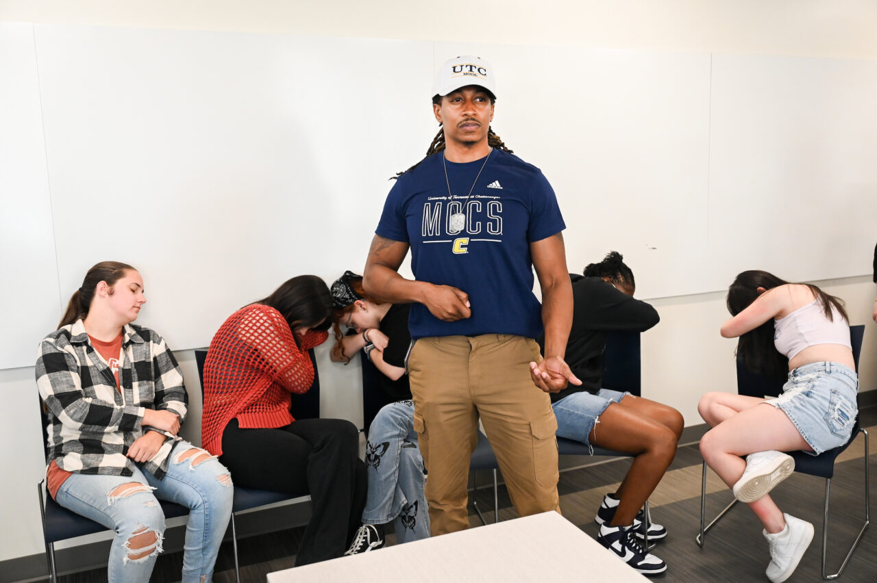 Junior social work major James Robinson, a U.S. Army veteran, stands guard during a "Still Images of Trust" exercise. Photo by Angela Foster.