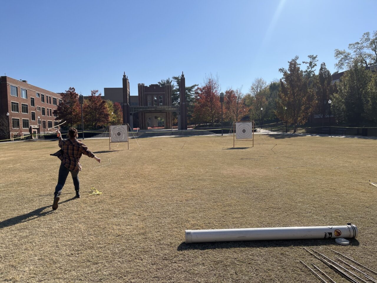 Anthropology major Ava Lowery uses an atlatl—a spearthrower—and a dart to practice traditional hunting techniques. Photo credit: Dr. Brooke Persons.