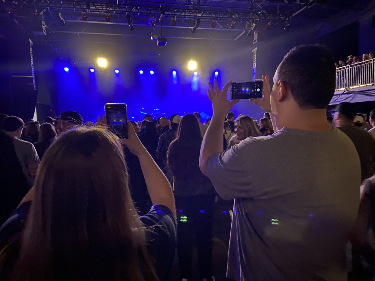 Neka Long, left, and James Ortiz take photos inside the Signal, the venue they chose for their project in the Always Go to the Show course.