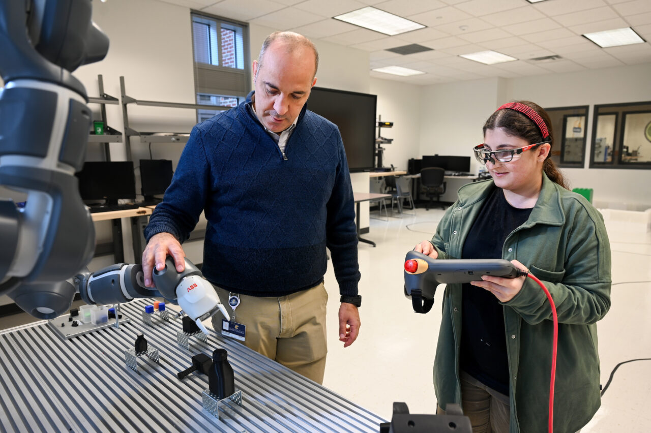 Dr. Erkan Kaplanoglu works with December graduate Fatimah Musa in the Robotics Lab. Photo by Angela Foster.