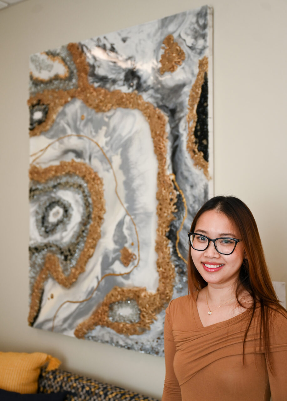 Hao Luong stands in front of "Metal."