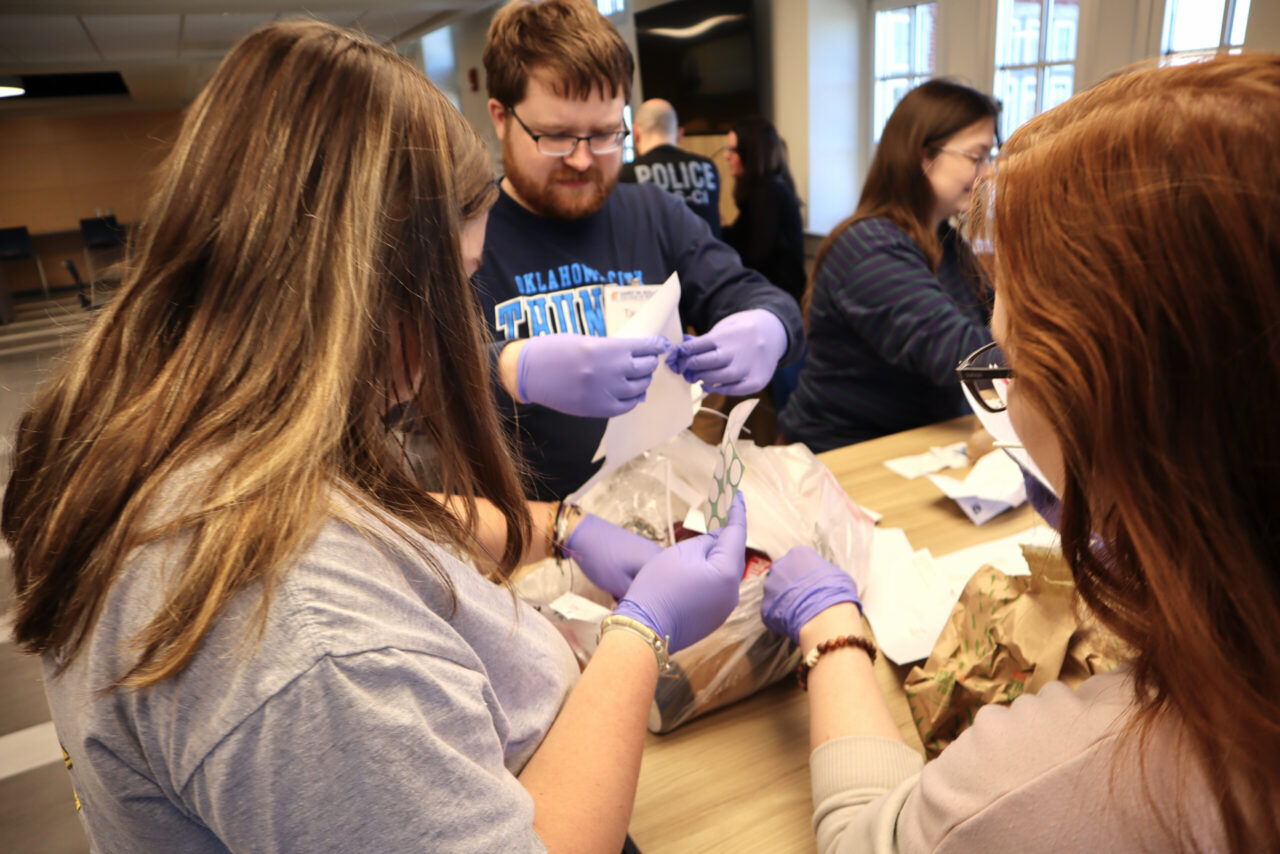 UTC forensic accounting students evaluate potential evidence—including trash—during the daylong seminar. Photo by Katrina Craven.