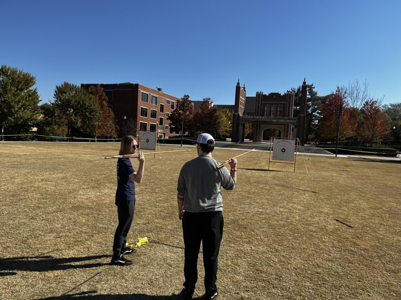 Chase Heistand, an anthropology intern, teaches another student how to correctly aim the dart thrown by an atlatl—a spearthrower. Photo credit: Dr. Brooke Persons.