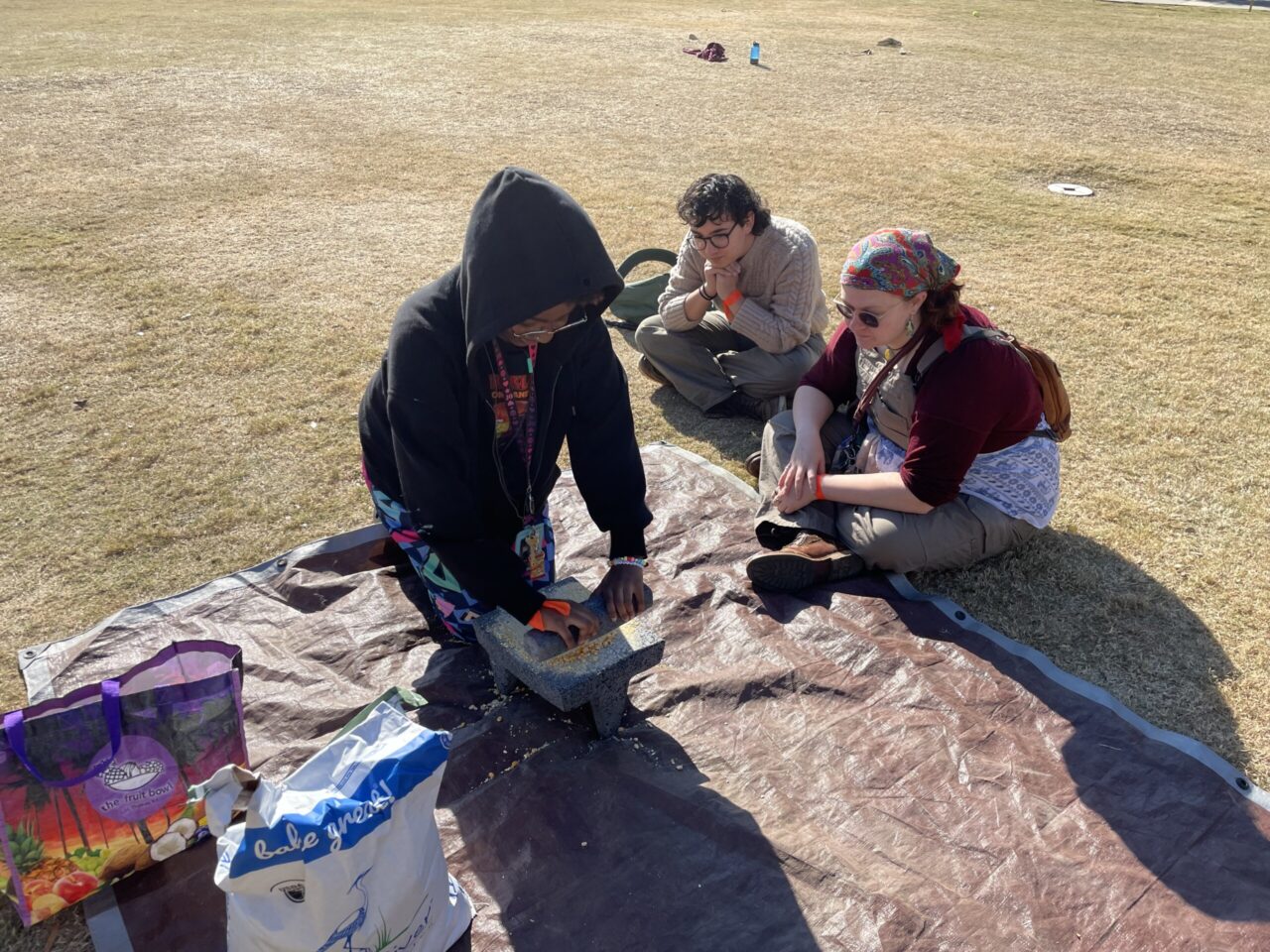 To grind corn, participants use a metate, a grinding stone common among agricultural societies in the Americas. Photo credit: Rose Lundberg.