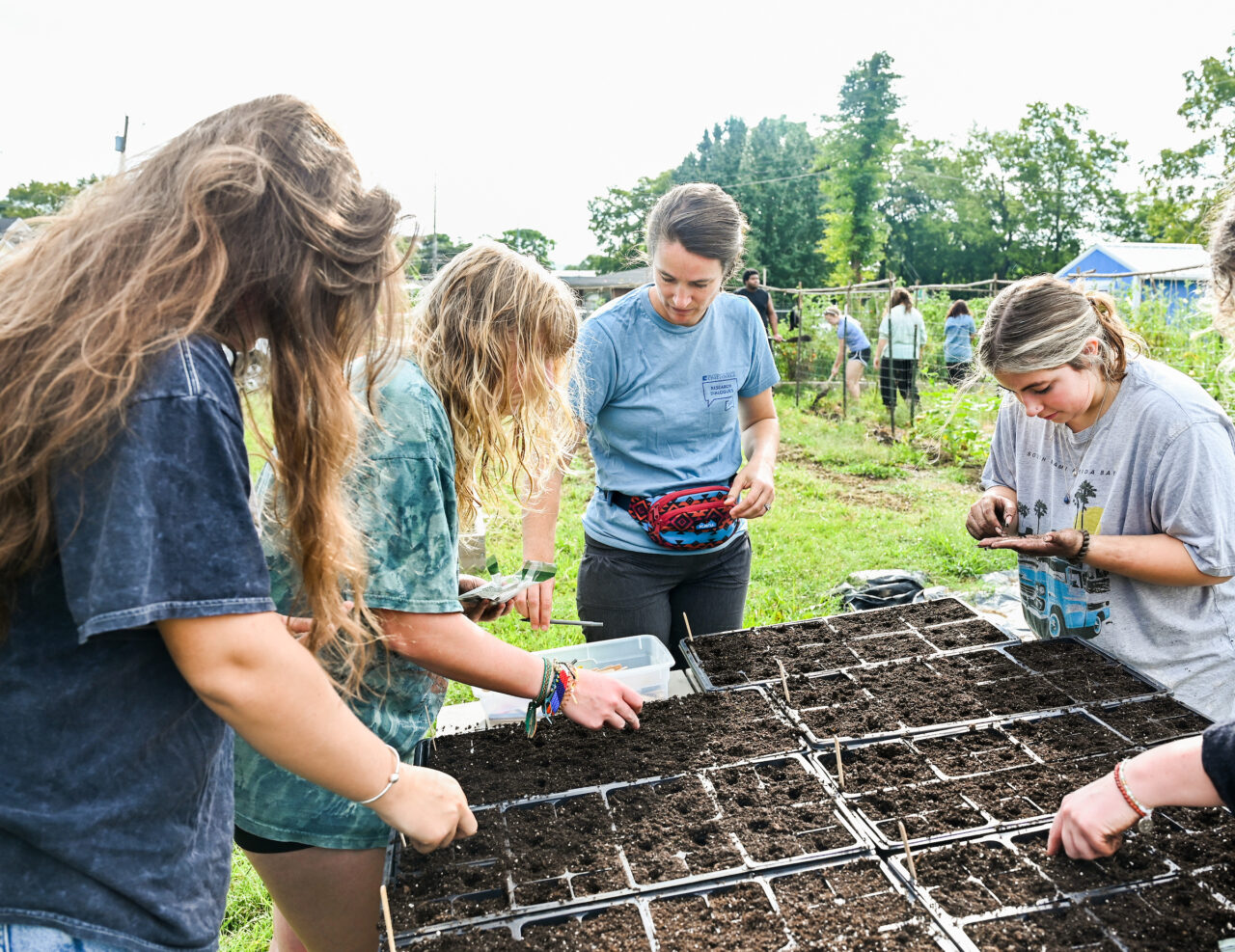 Catherine Meeks Quinlan, center, in her Nature and Society: Introduction to Environmental Studies class at The Bethlehem Center garden.