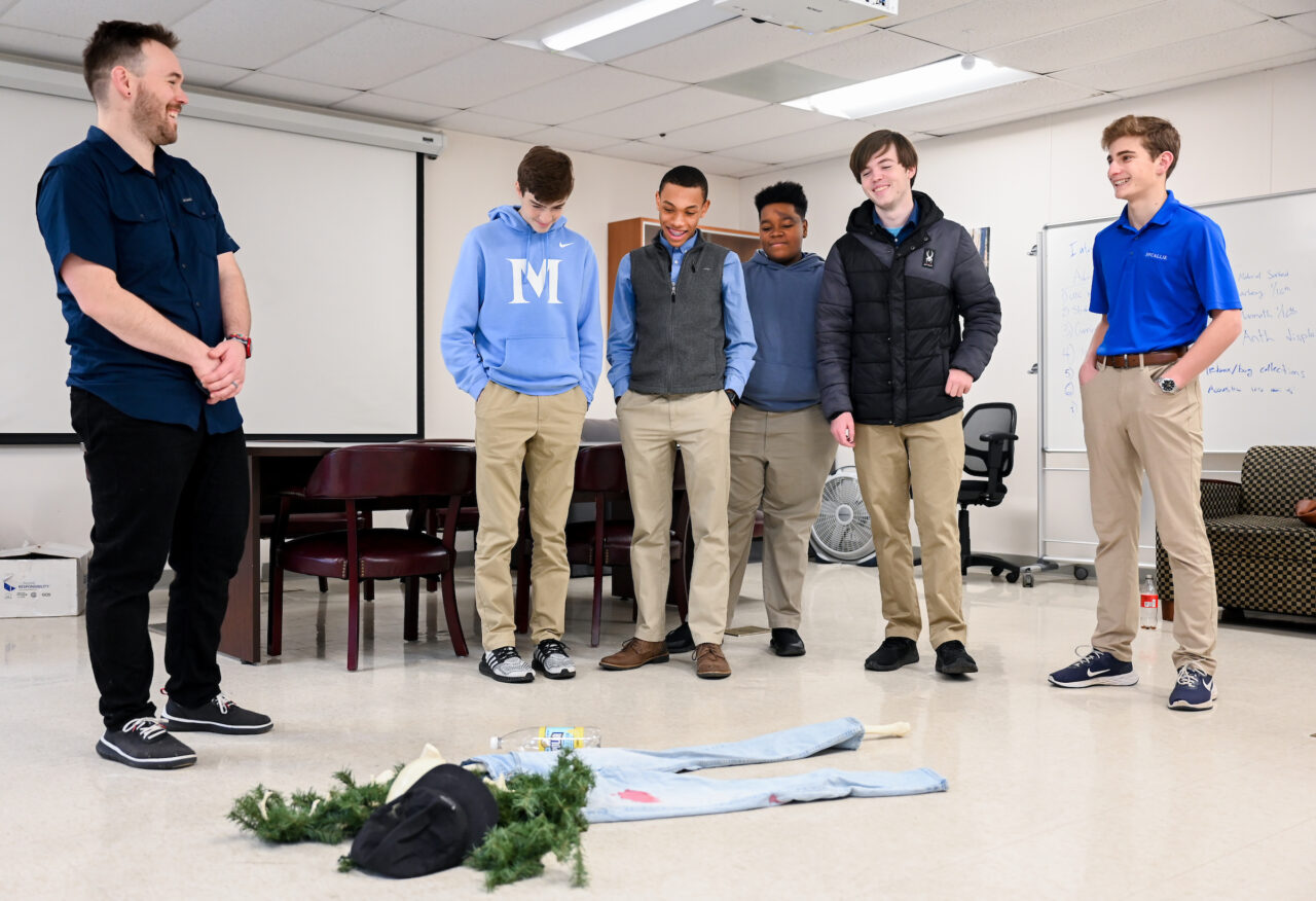 UTC Lecturer in Biological Anthropology Derek Boyd, left, takes McCallie School students Ethan Wagner, Isaiah Summey, Alex Senter, James Adams and Aubrey Raff through a mock crime scene. Photo by Angela Foster.
