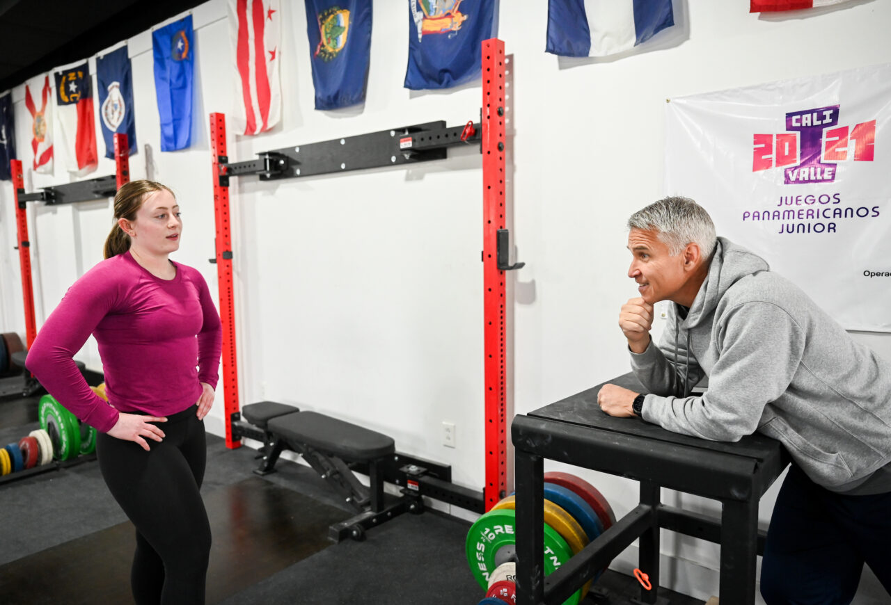 Olivia Reeves talks with her coach, Steve Fauer, at Tennessee Speed and Strength.