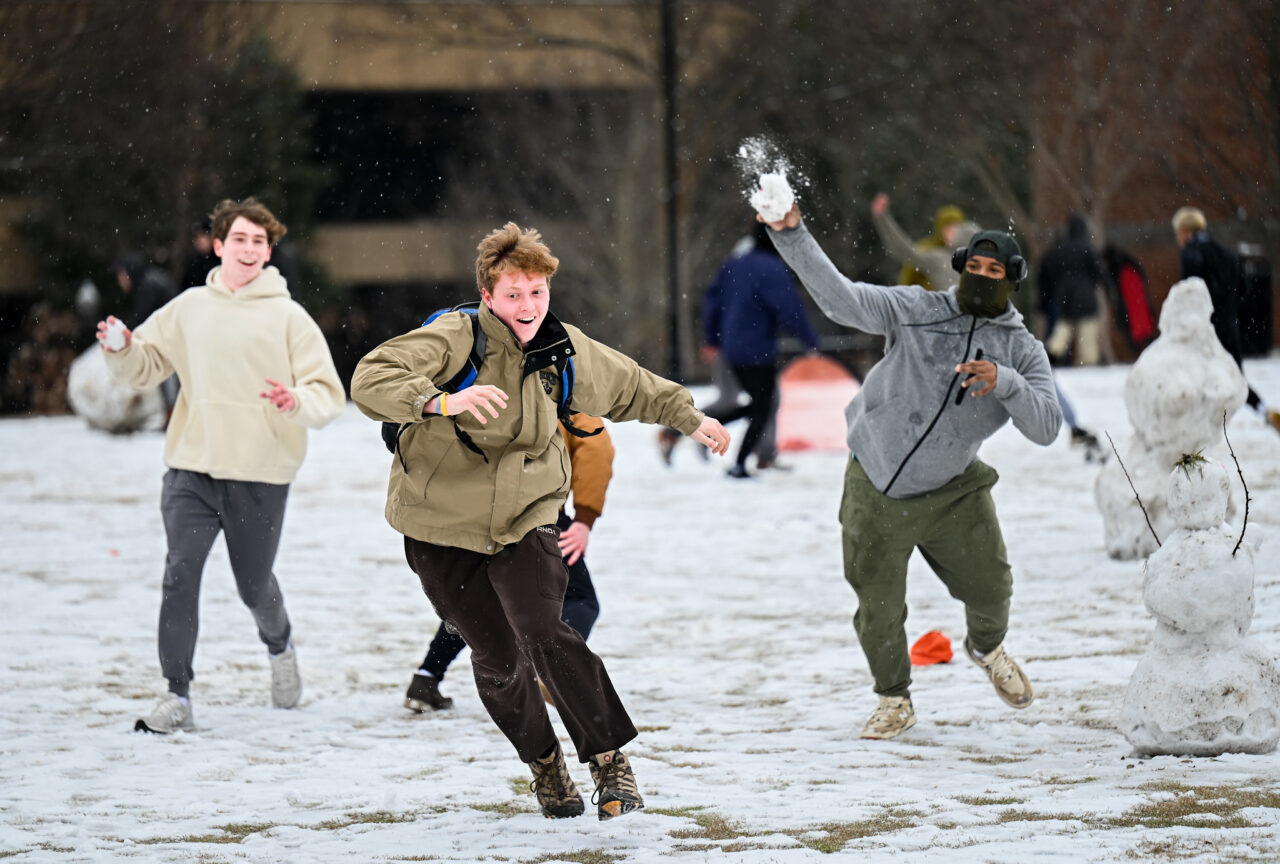 Students play in the snow Monday, Jan. 15, 2024 on Chamberlain Field.